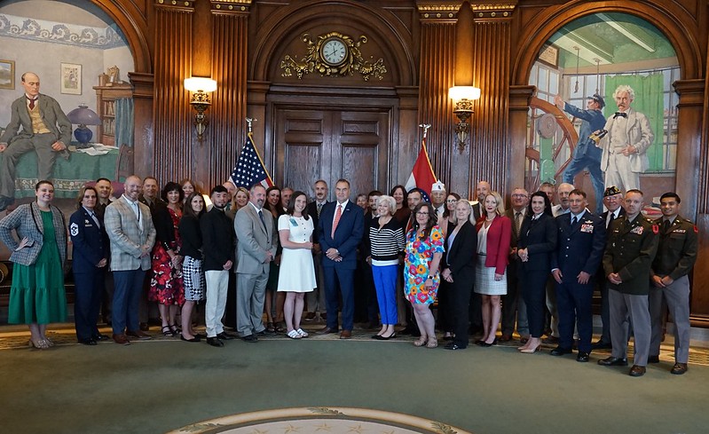 Gov Mike Kehoe with representatives from the organizations that make of the state team.