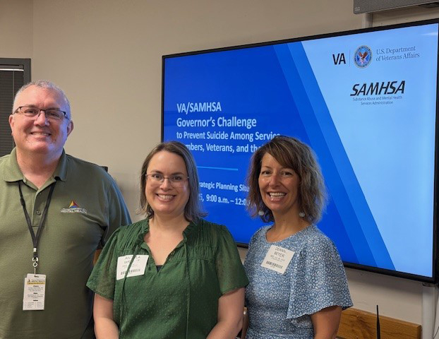 3 people standing in front of screen