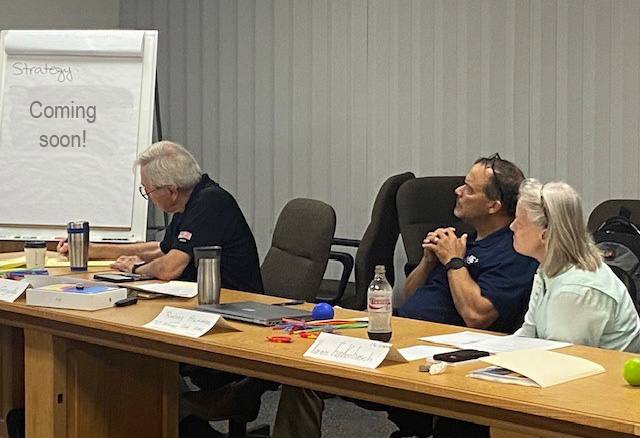 3 team members discussing new strategies